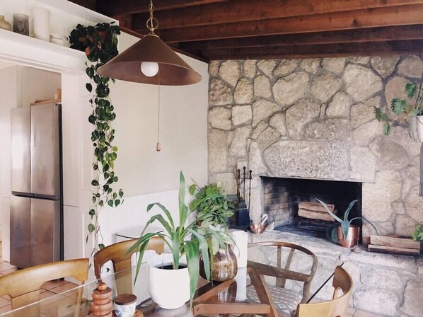 Dining room with functioning, natural coquina rock fireplace.