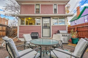 Create Lasting Memories in Our Inviting Backyard: A Spacious Table Surrounded by Plenty of Comfortable Chairs Awaits Your Gatherings. Fire Up the BBQ Grill and Enjoy Delicious Cookouts While Basking in the Beautiful Outdoor Atmosphere.