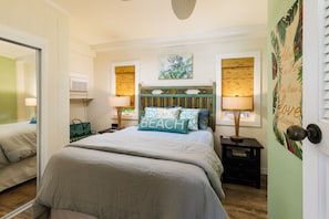 Queen bed with air conditioning in bedroom