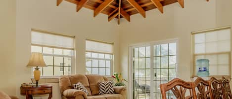 Living room with ocean views and vaulted ceiling.