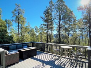 Large deck with breathtaking views, comfortable seating, fire table, and outdoor heater
