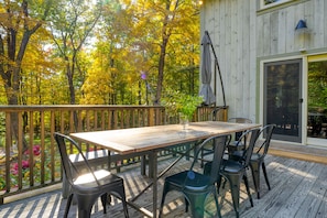 Large deck with an outdoor dining table, seating, and BBQ/grill.