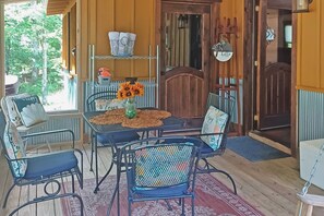 Covered screened porch just steps away from the outdoor deck, hot tub, fire pit and grill