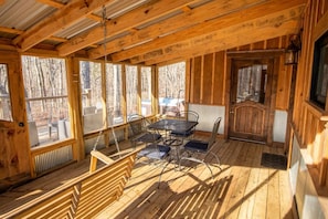 Screened in porch, with seating for four and swing to relax in