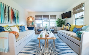 Living room with two twin daybeds (4 twins) in the Geneva Suite