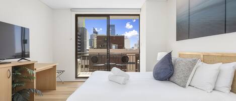 Enjoy views of the city from your bed 