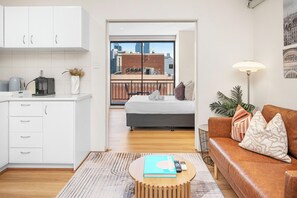 Your comfortable home away from home.  The harmonious flow from our modern kitchen and living space into the private bedroom, which opens directly onto a charming balcony – perfect for enjoying fresh air and city views.