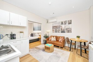 Experience the harmonious flow of our open-plan studio. From the convenient kitchen, perfect for preparing meals, through the inviting lounge space, to the tranquil sleeping area, every zone is designed for comfort and ease of living