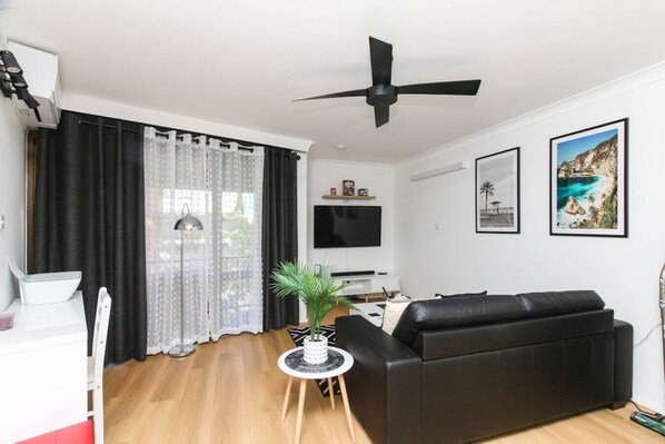 Living room with a Smart TV and a private balcony