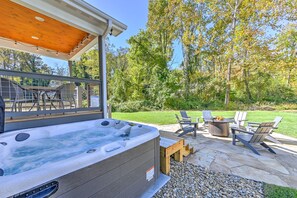 6 person hot tub, brand new, with stone patio in background