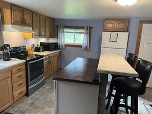 Spacious kitchen with convenient island/bar seating