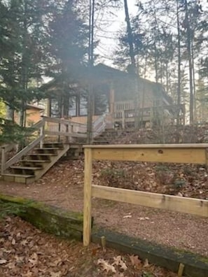 Lakeside of the cabin with stairs down to the private dock.