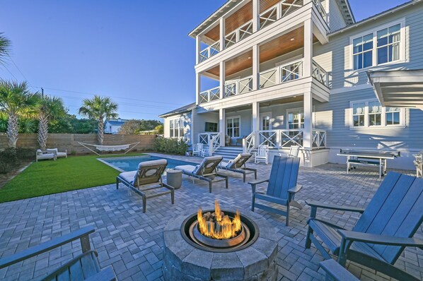 Perfect backyard with fire pit, outdoor kitchen, ping pong table and heated pool