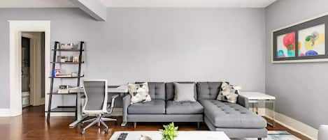 Living room with comfortable Crate and Barrel sofa and Quartz coffee table