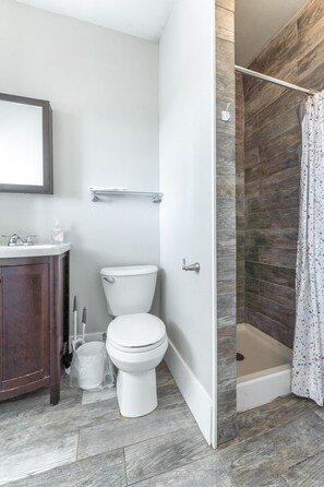 Indulge in spa-like relaxation in this spacious, serene bathroom.
