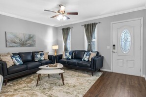 Relax in style in the living room, featuring two cozy leather couches perfect for unwinding after a day of adventure.