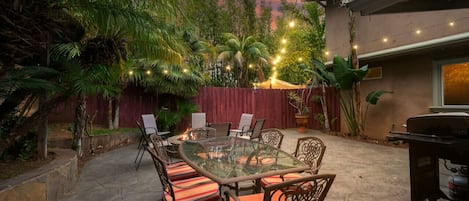 Welcome to your tropical oasis with patio table, BBQ grill and bonfire pit