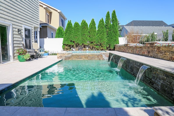 Heated salt water gunite pool with waterfalls and spa