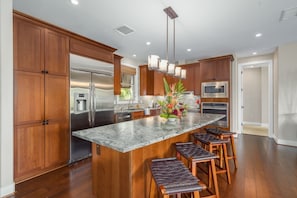 Large kitchen with an island that seats 4, leather finished granite counter tops, stainless steel appliances.
