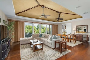 Main living area.  Open floor plan, grass and Mahogany accent trimmed vaulted ceiling.
