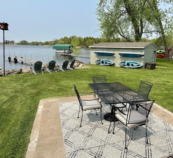 Backyard equipped with kayaks and paddle boards during the summer months. 