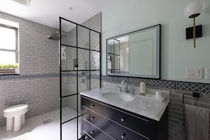 Immaculate bathroom with rain shower and beautiful design. 