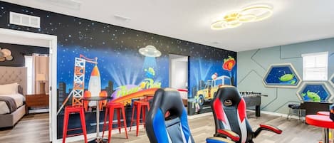 Pizza Planet themed game room. Gaming chairs for PS5 on a 65" TV!