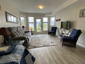 Bright living room with lake view and fireplace.