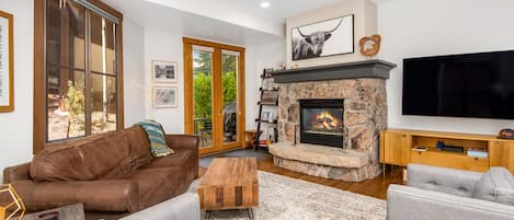 The living room with fireplace, tv, and plenty of seating!