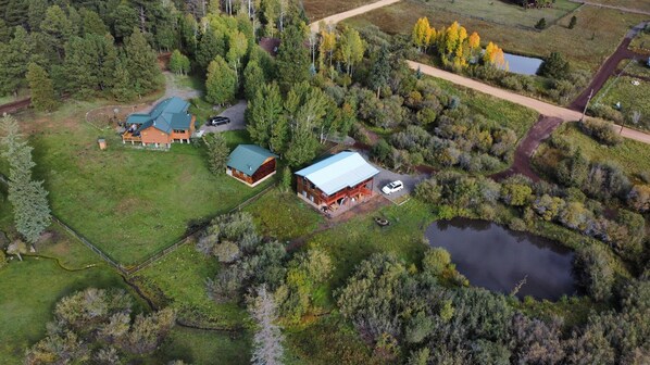 Aerial view of all 3 cabins and the pond 