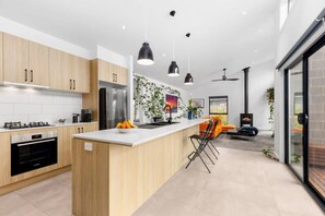 Fully appointed kitchen has a dishwasher, electric oven and gas cooktop