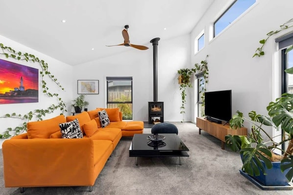 High ceilings and extensive glazing invite all day sunshine into the home