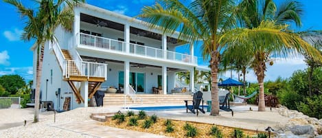 View of backyard from the walkway to the dock area. 4 chaise loungers