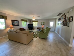 The living room includes a 50" tv and a new queen sleeper sofa.