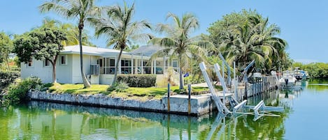 Canal side view of the home showing the ample dockage and water access.