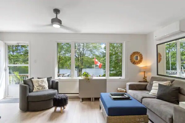 Lovely open and bright living room looking over the lake