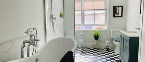 Beautiful spacious bathroom with walk-in shower and roll top bath