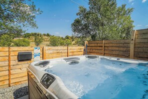 Take a soak in the hot tub after a long day of hiking! The hot tub is shared with the guesthouse on the property and is enclosed with a fence for privacy.