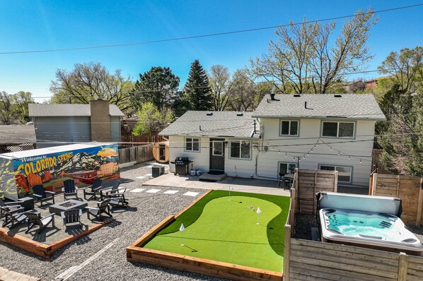 Your Backyard Adventure Awaits! Unwind in the hot tub, enjoy the putting green, fire up the BBQ, or gather around the fire pit in this incredible outdoor oasis. Perfect for memorable moments!