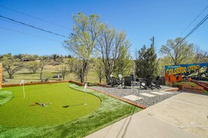 Private Putting Green & Relaxing Backyard! Practice your swing on the putting green or kick back by the fire pit in this outdoor oasis, complete with stunning views and vibrant local art.