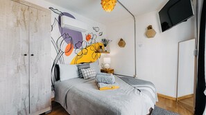 The bedroom comfortably accommodates up to 2 guests on a dreamy queen-size bed.