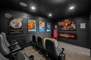 Enjoy a show in the home theater with theater seating for 7 and a plush bean bag