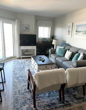 Living room has sleeper sofa, Roku TV, and games/puzzles/movies for all ages!