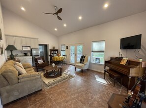 Spacious living room with simple kitchen (microwave, fridge, hot plate)