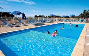 Enjoy table tennis, a sports ground, a heated outdoor pool and more at this residence.