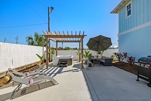 Backyard Oasis offers a grill, seating area, loungers, hot tub & hammock