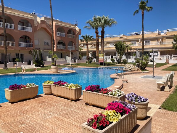 1 of 2no large communal pools with beautiful gardens to unwind & cool off