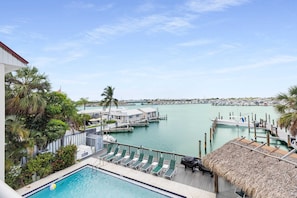 View of harbour, shared pool, tiki bar, grills and dockage