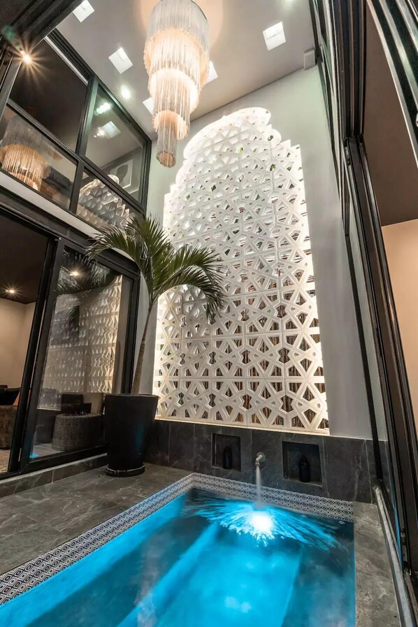 A heated saltwater pool with a 2-story Moroccan arch is the heart of the living area. 