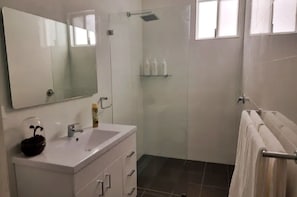 Bathroom with complimentary shampoo, conditioner, soap, towels